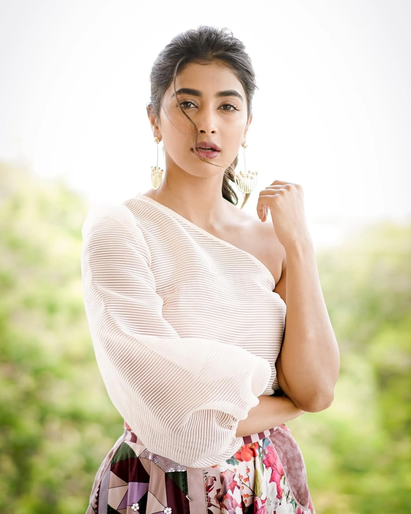 Pooja Hegde Posing Outdoors in Soft White Top with Nature