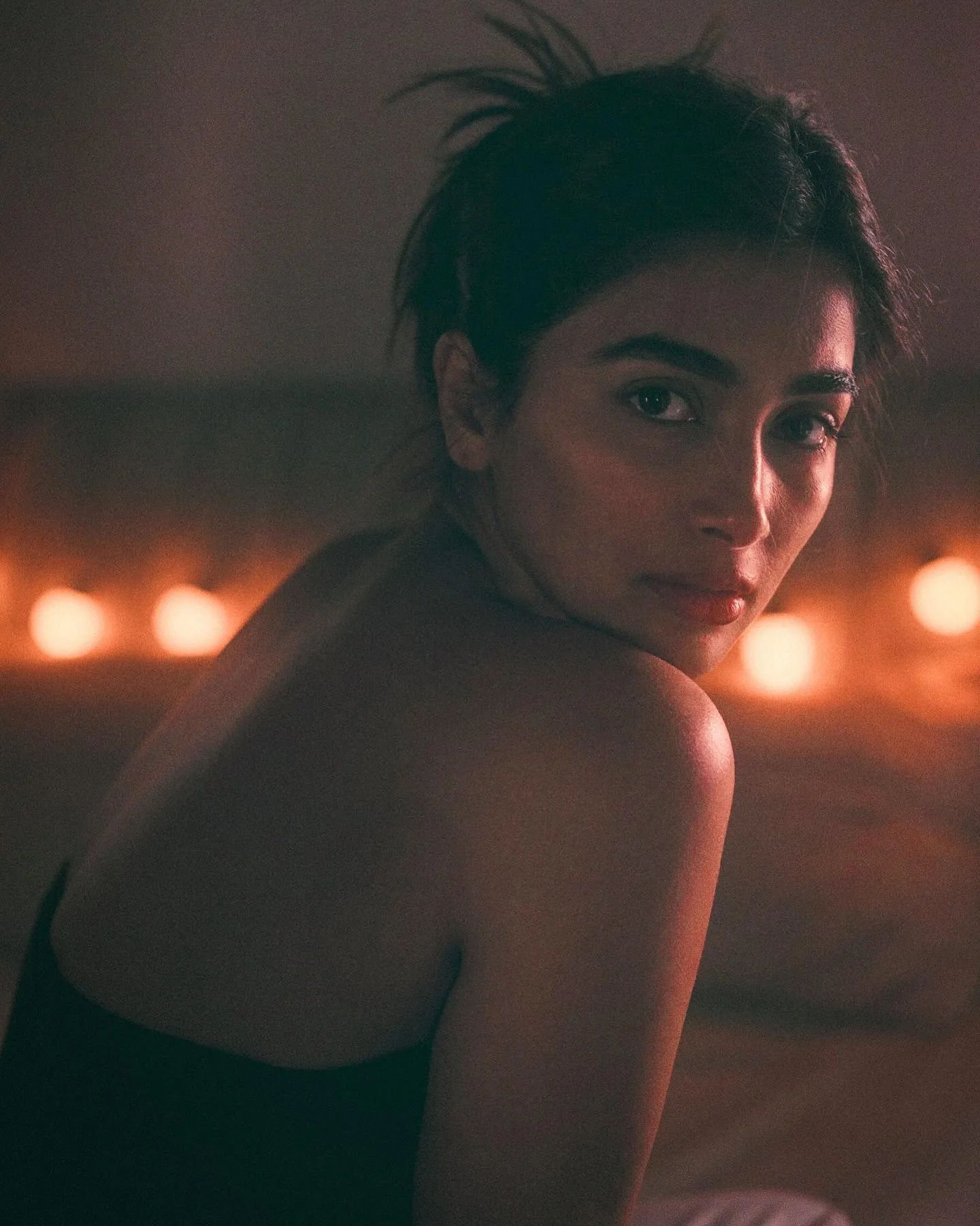 Pooja Hegde Posing Under Warm Lights in Elegant Black Dress