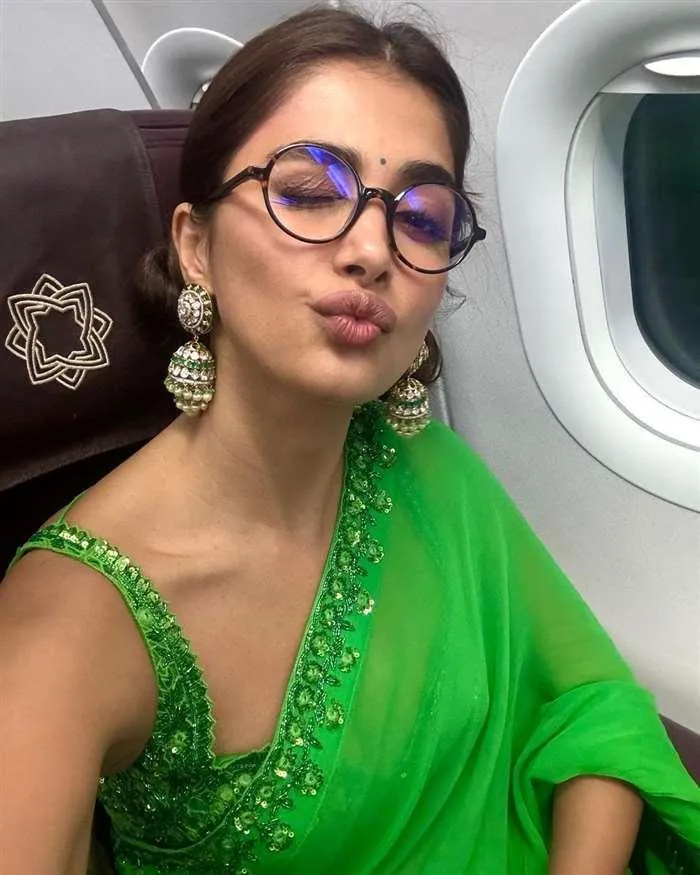 Pooja Hegde Pouting in Green Saree on Airplane Seat Image