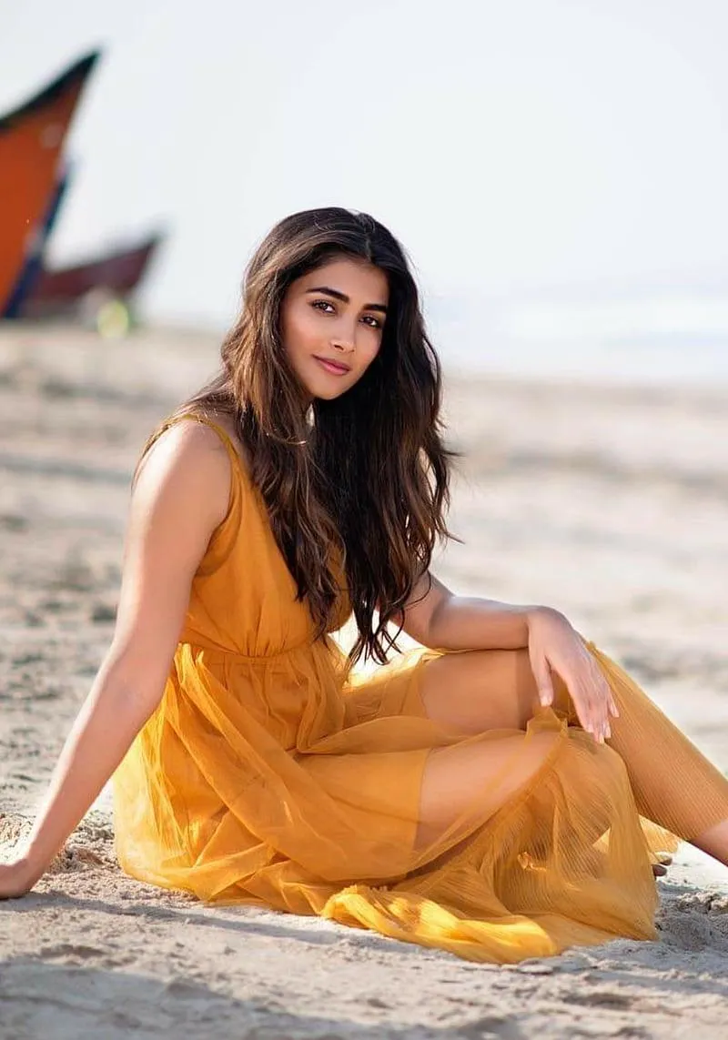 Pooja Hegde Relaxes on the Beach in a Yellow Summer Dress