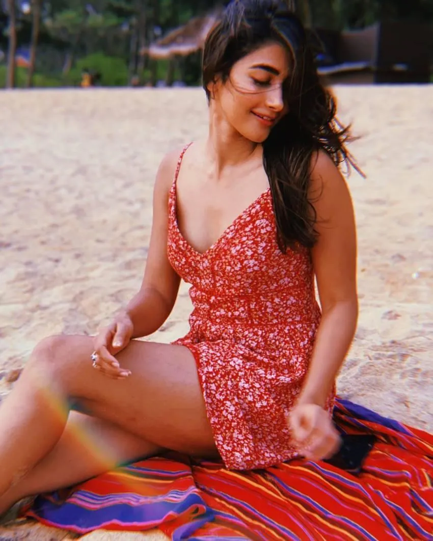 Pooja Hegde Relaxing on the Beach in a Red Summer Dress
