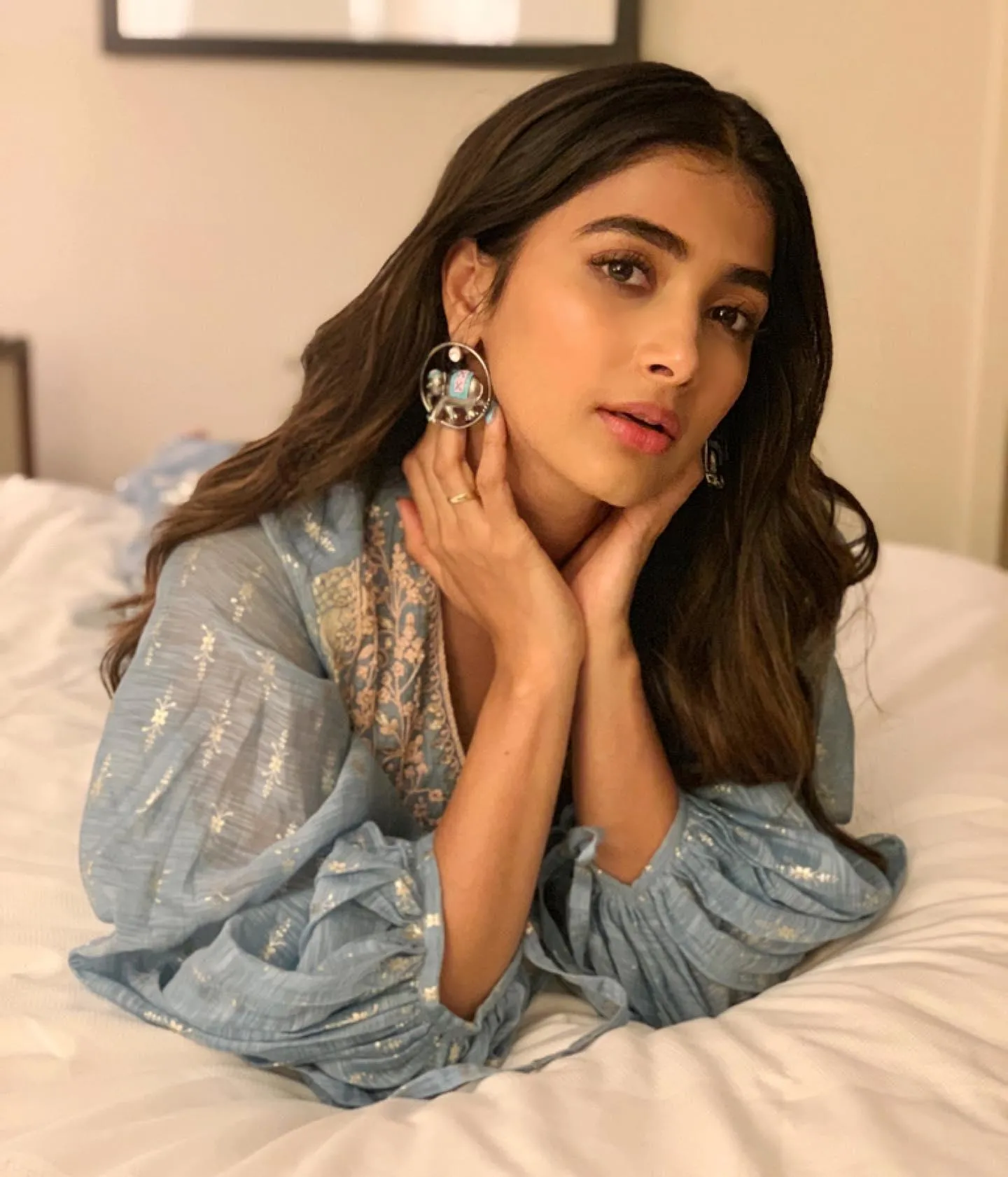 Pooja Hegde Resting with Hands on Neck in Soft Light