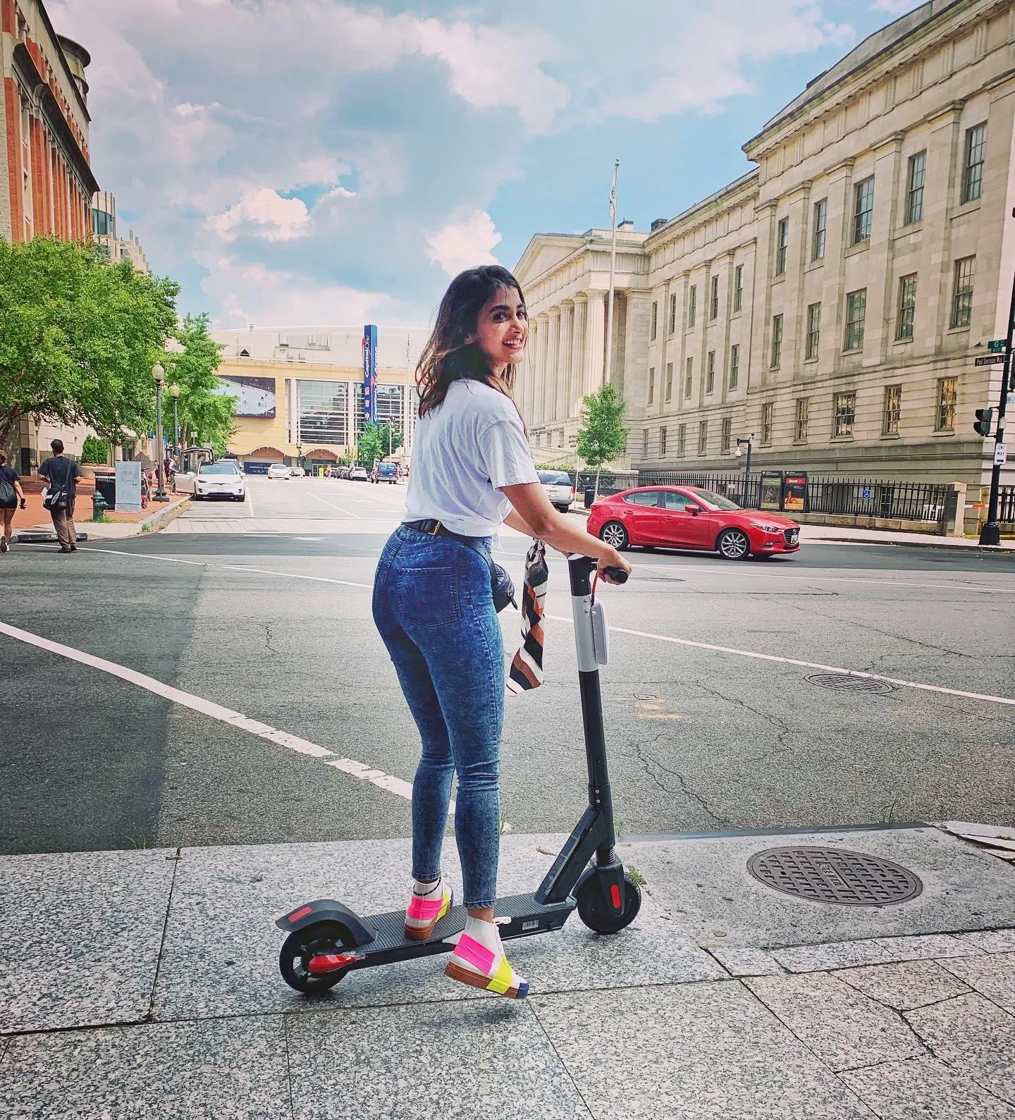 Pooja Hegde Riding Electric Scooter on a City Street