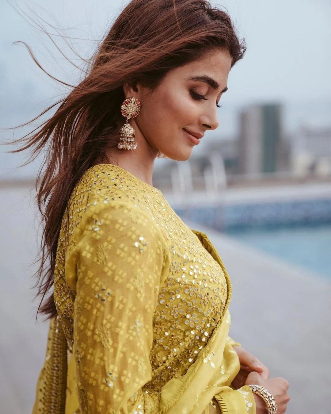 Pooja Hegde Side Profile in Yellow Saree Near the Water