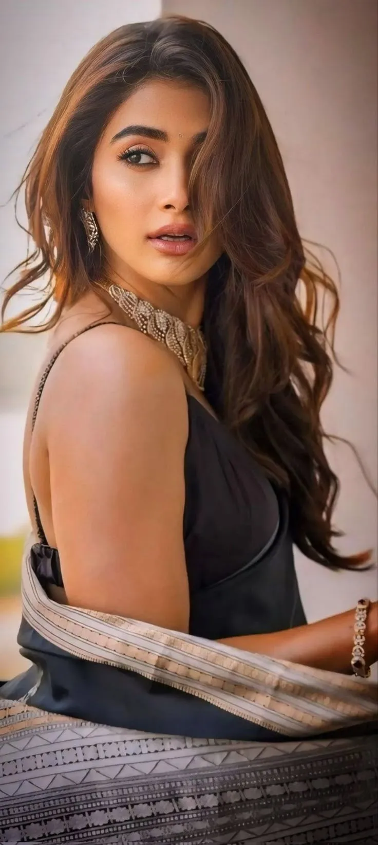 Pooja Hegde Side Profile Wearing Black Outfit Sitting