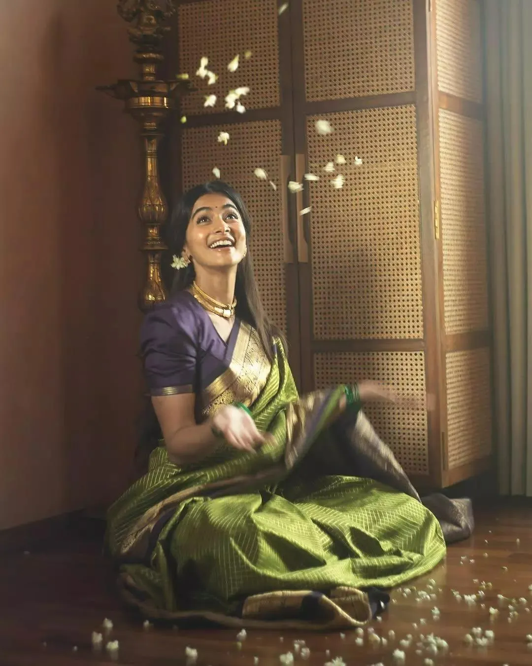 Pooja Hegde Sits Gracefully in a Green Silk Saree Indoors