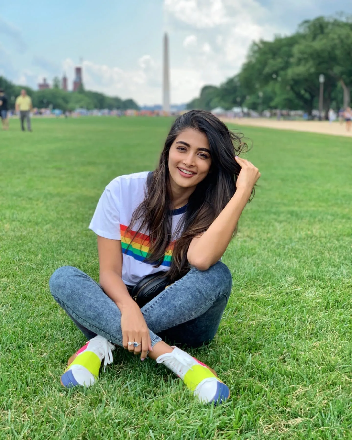 Pooja Hegde Sits on Green Grass in Casual Outfit Wallpaper