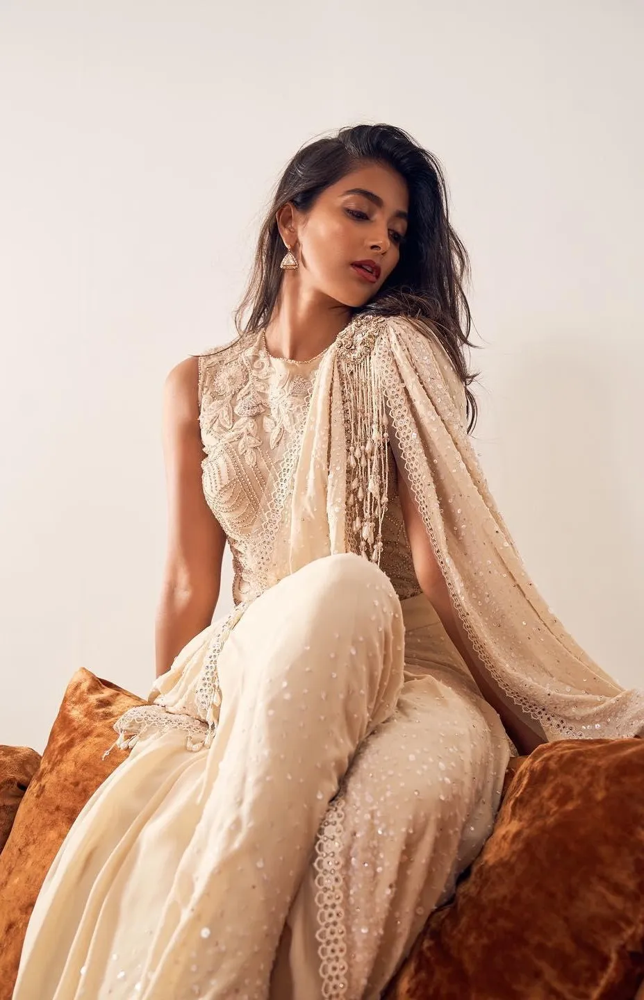 Pooja Hegde Sitting Calmly in a Soft Beige Outfit