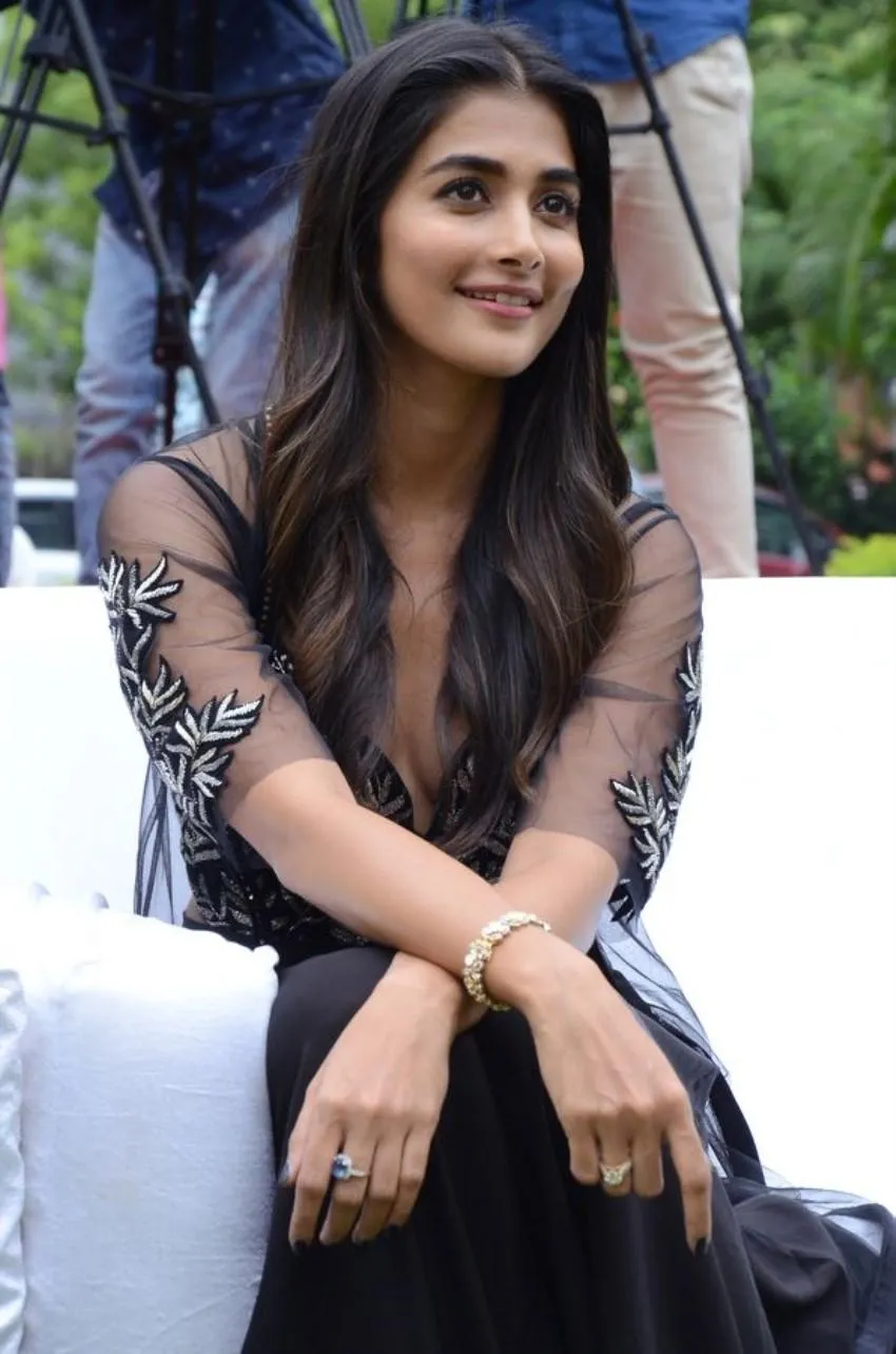Pooja Hegde Sitting in Black Dress Smiling Gracefully