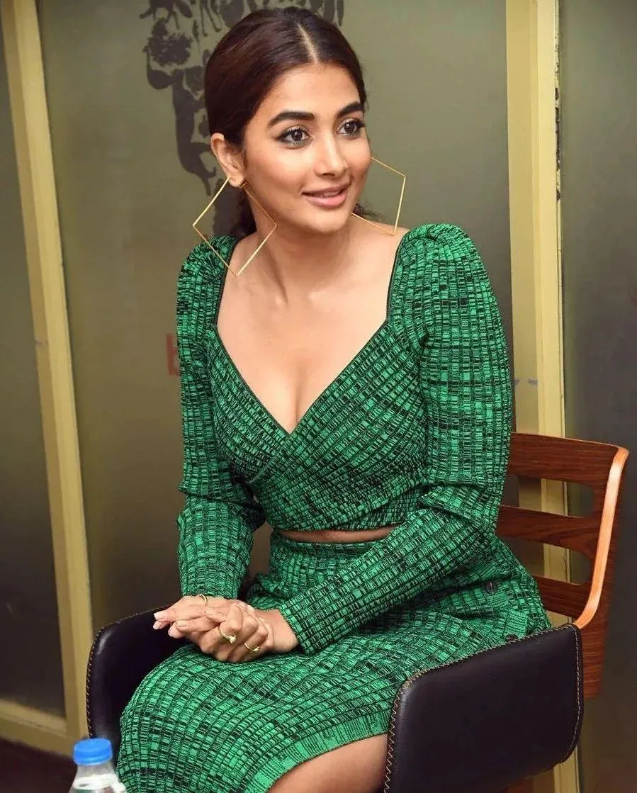 Pooja Hegde Sitting in Green Dress During An Event