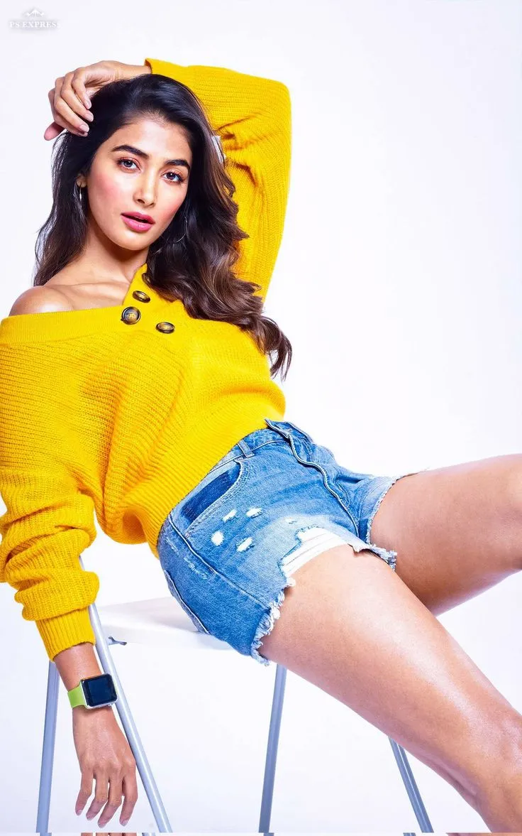 Pooja Hegde Sitting in Yellow Sweater and Shorts Wallpaper