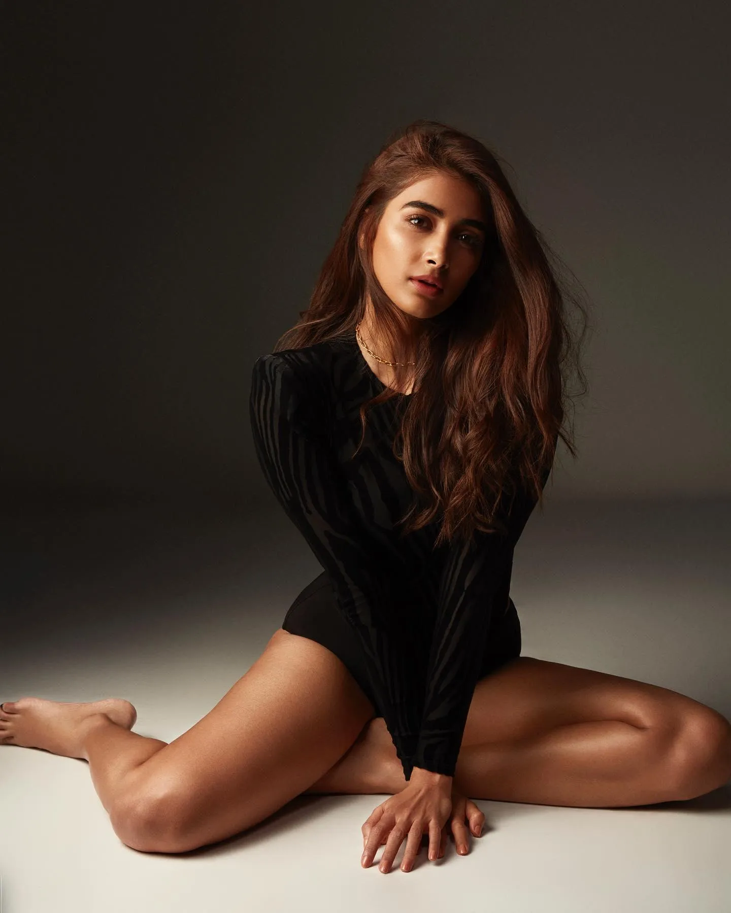 Pooja Hegde Sitting on Floor in Bold Black Outfit Pose