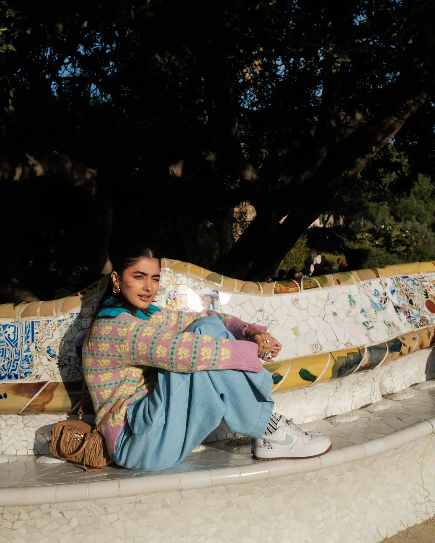Pooja Hegde Sitting Outdoors in Casual Outfit with Sneakers