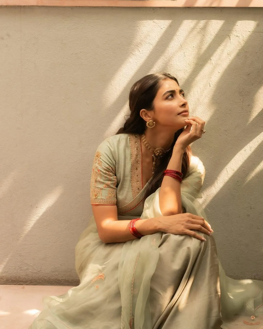 Pooja Hegde Sitting Thoughtfully in Traditional Wear
