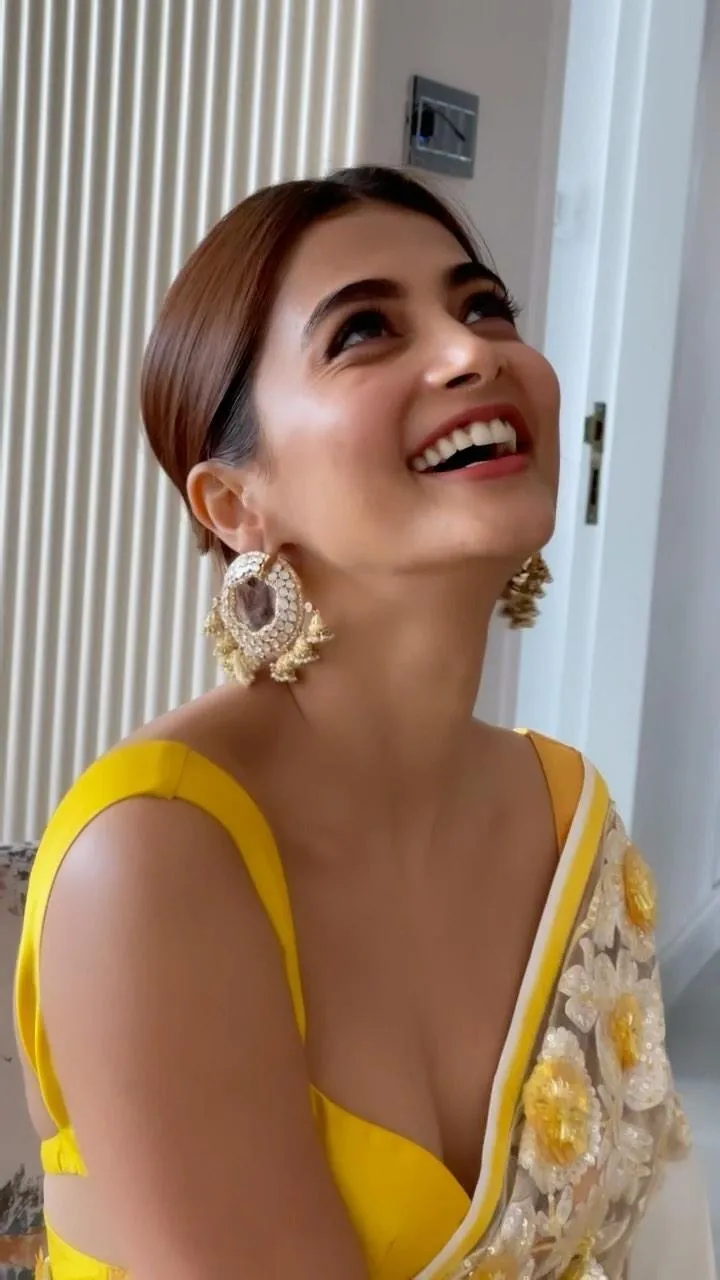 Pooja Hegde Smiles Brightly in Floral Yellow Saree Wallpaper