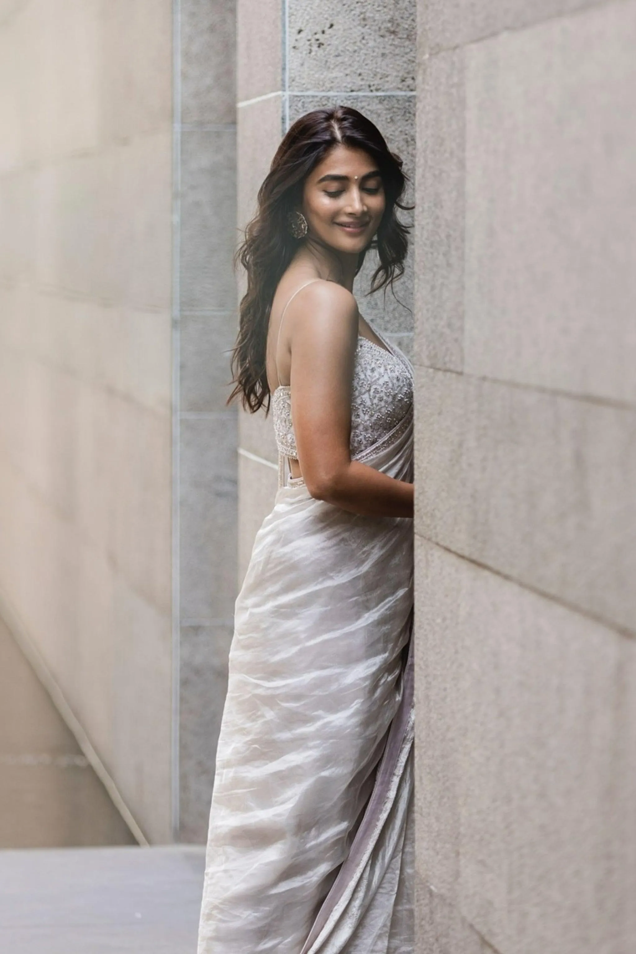 Pooja Hegde Smiles in Silver Saree By Stone Wall Wallpaper