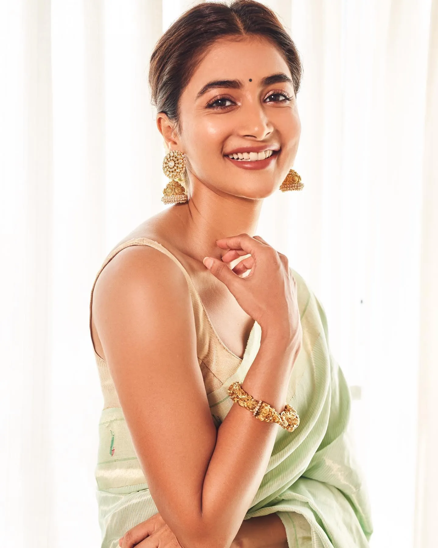 Pooja Hegde Smiling in Light Green Saree and Earrings