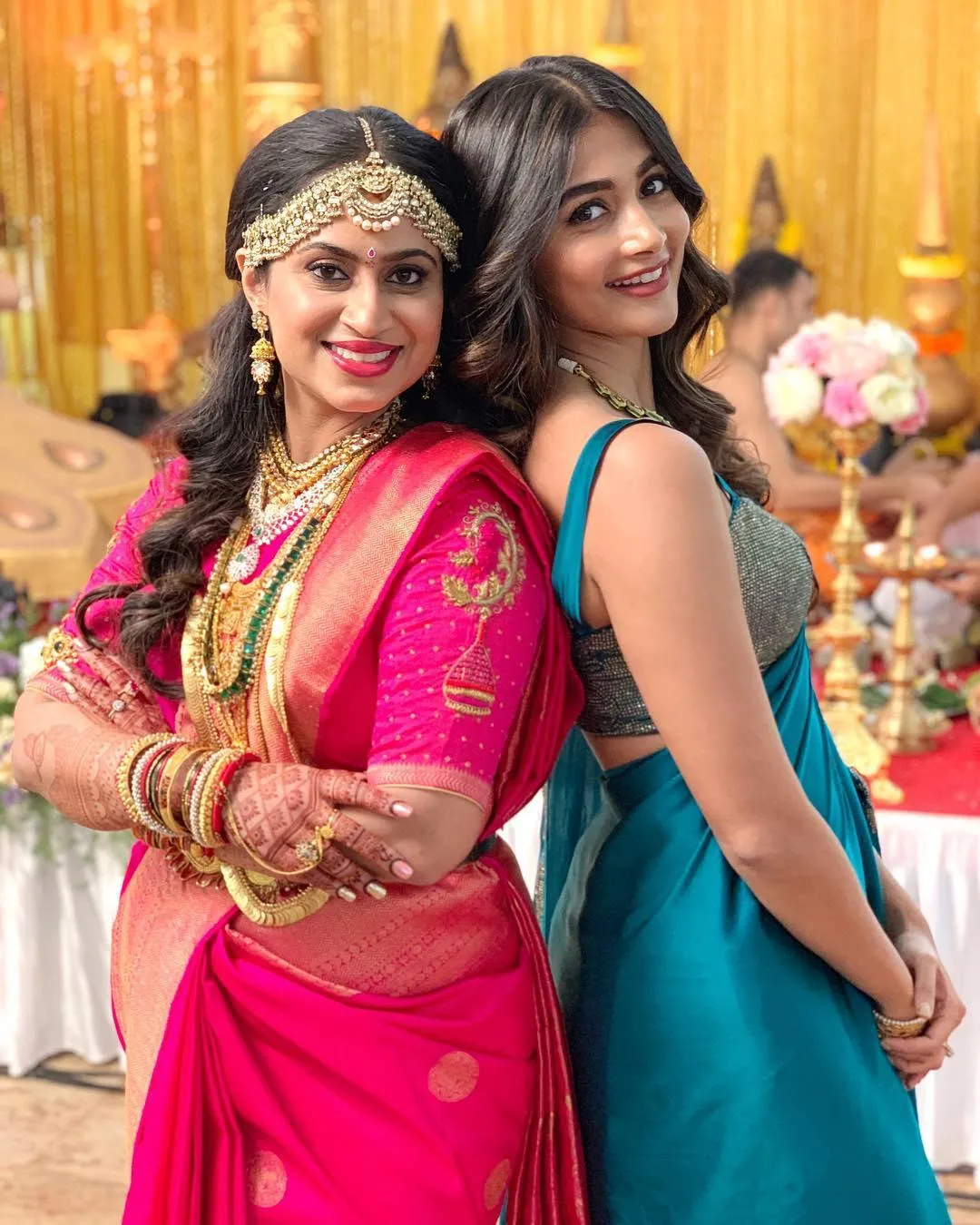 Pooja Hegde Smiling with Another Woman in Festive Attire