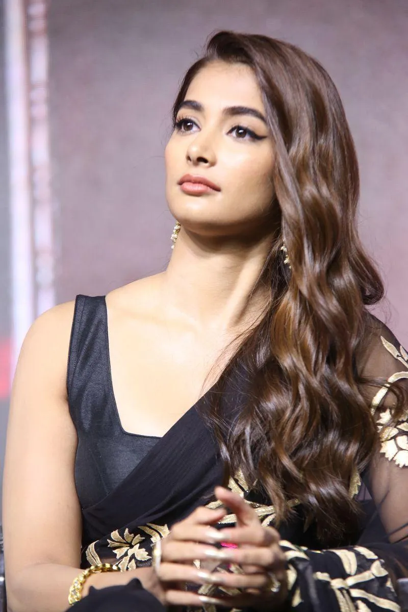 Pooja Hegde Stands Confidently in Black and Gold Saree