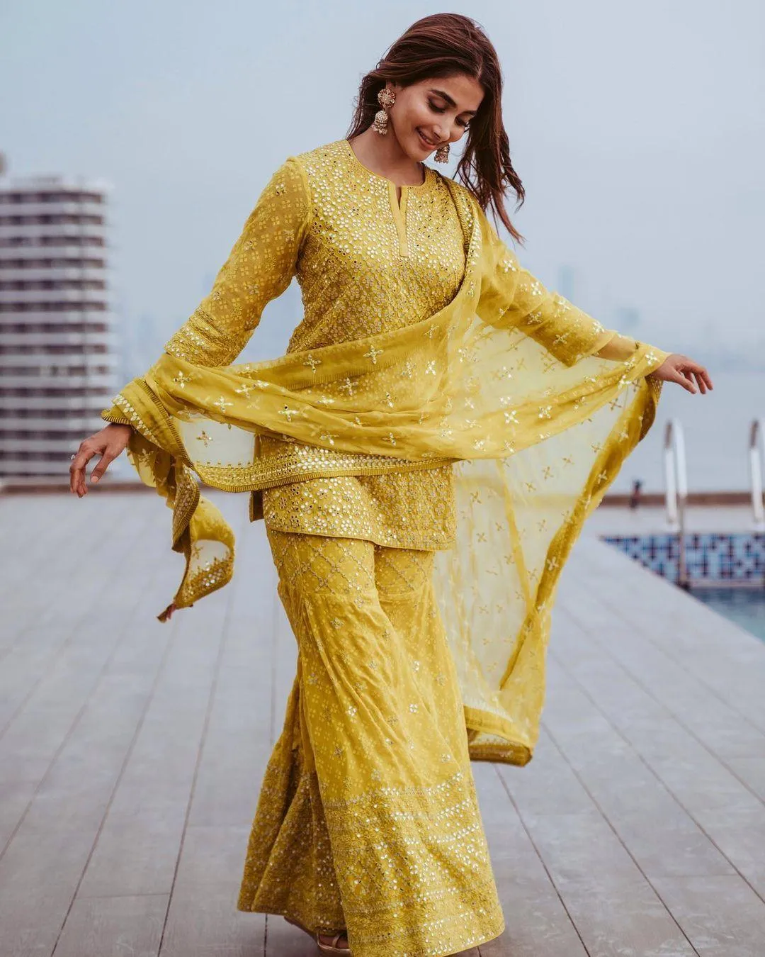 Pooja Hegde Twirling in Bright Yellow Outfit on Terrace