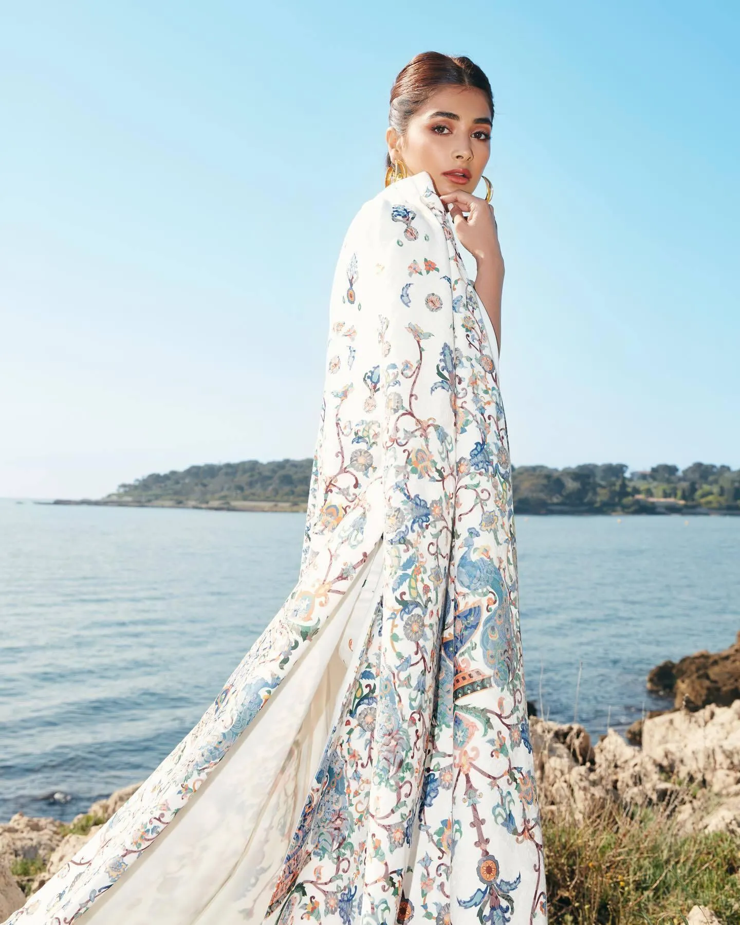 Pooja Hegde Wearing Long Floral Cape By the Sea Image