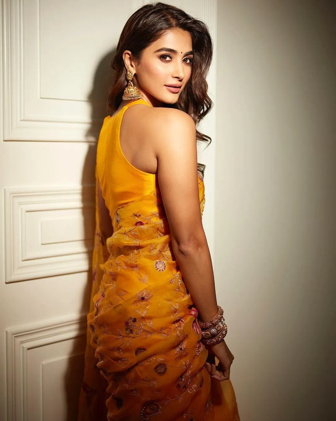 Pooja Hegde Wearing Orange Embroidered Saree with Pose