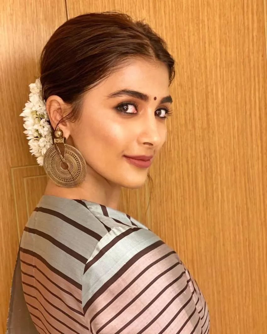 Pooja Hegde with Flowers in Hair Wearing a Striped Dress