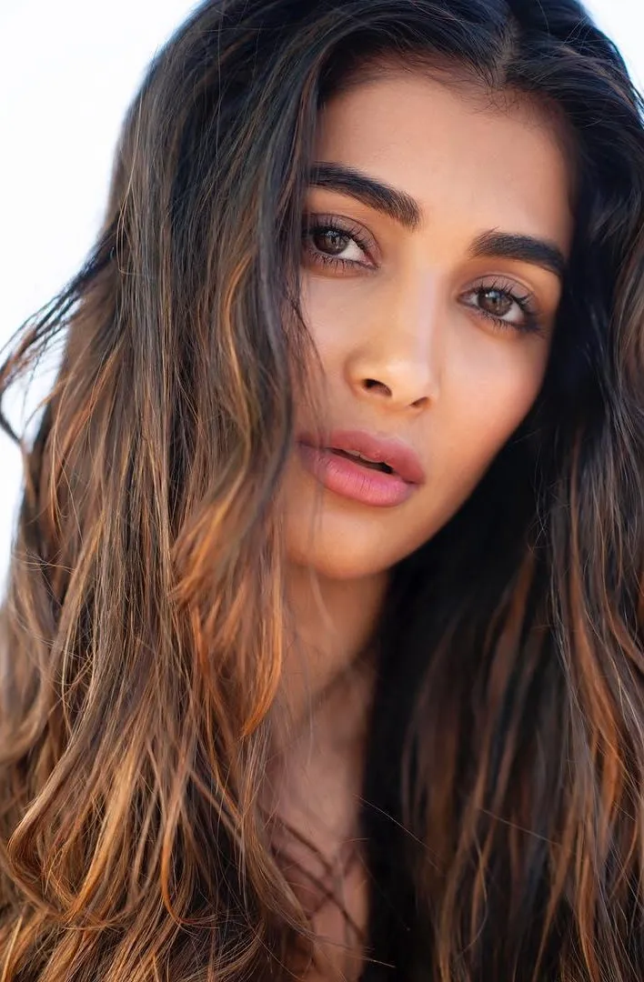 Pooja Hegde with Open Hair Wearing Striped Top Indoors