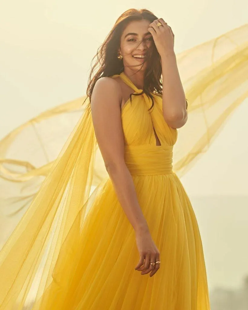 Radiant Pooja Hegde in Flowing Yellow Dress Under Sunlight