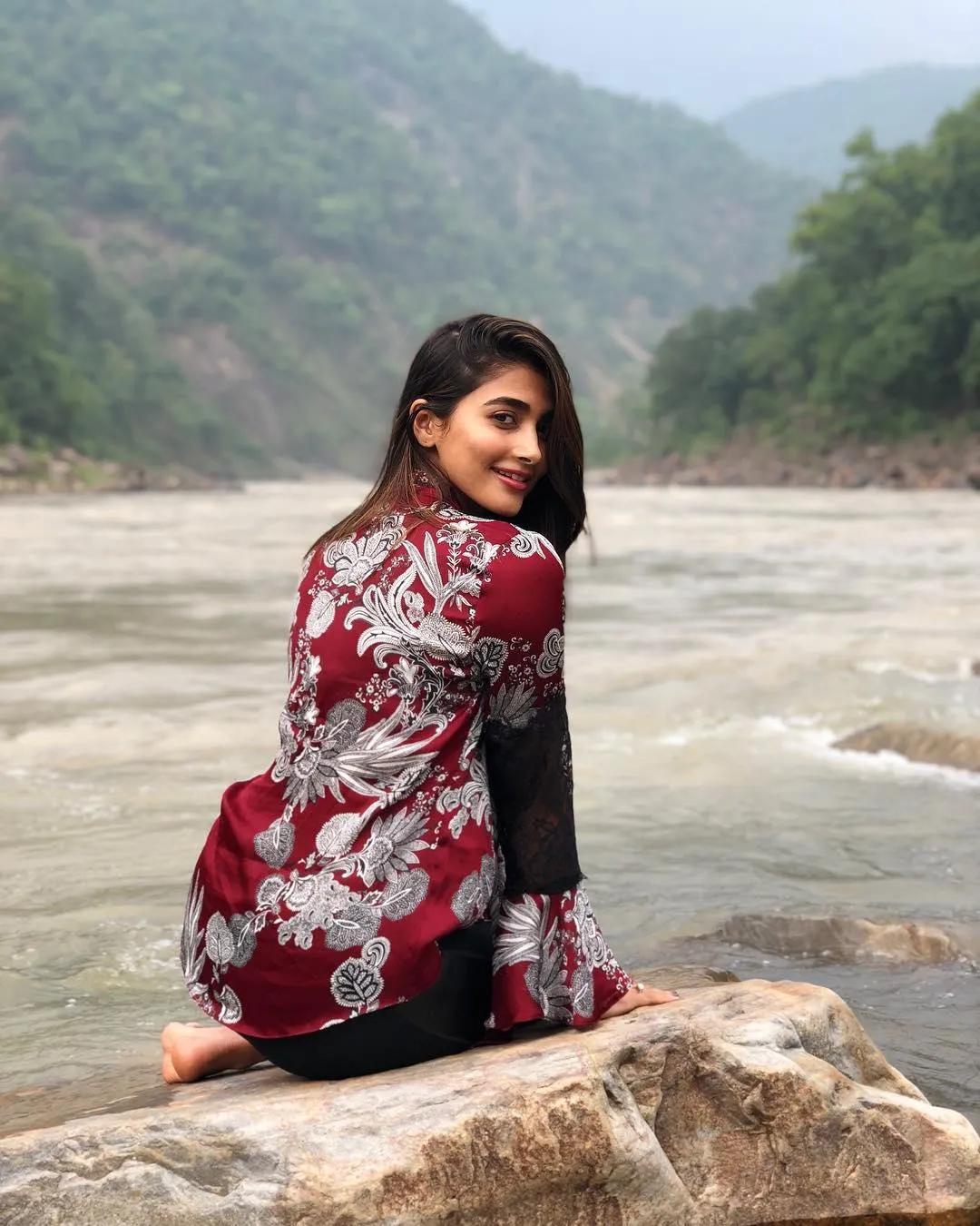 Relaxing Outdoors Pooja Hegde By the River Wallpaper