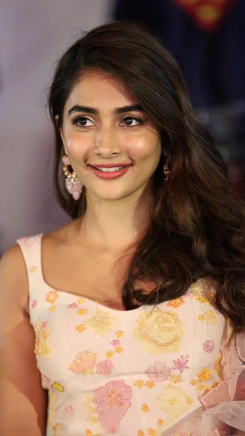 Smiling Pooja Hegde in Light Floral Dress At Film Event