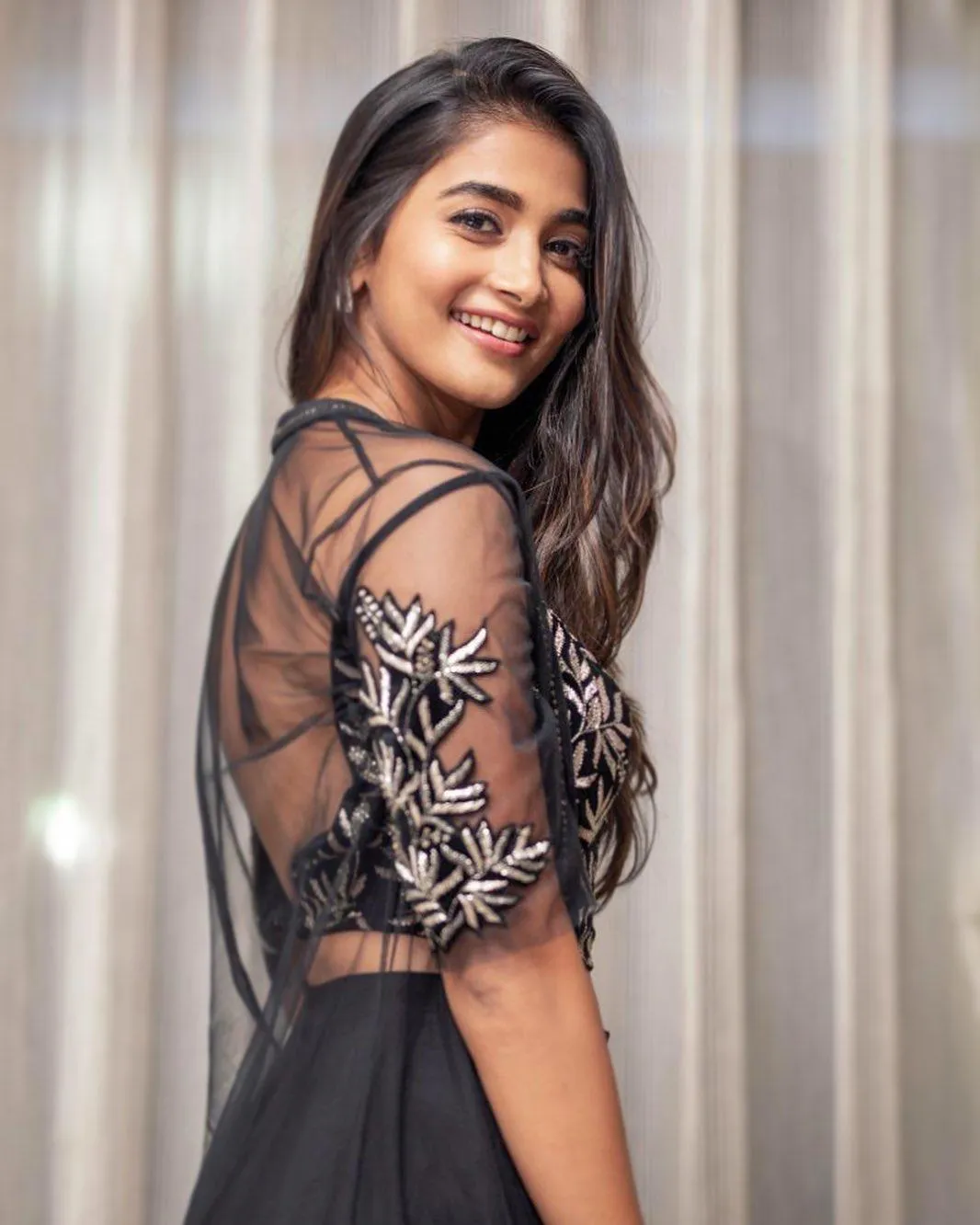 Wallpaper of Pooja Hegde in a Sheer Black Dress with a Smile