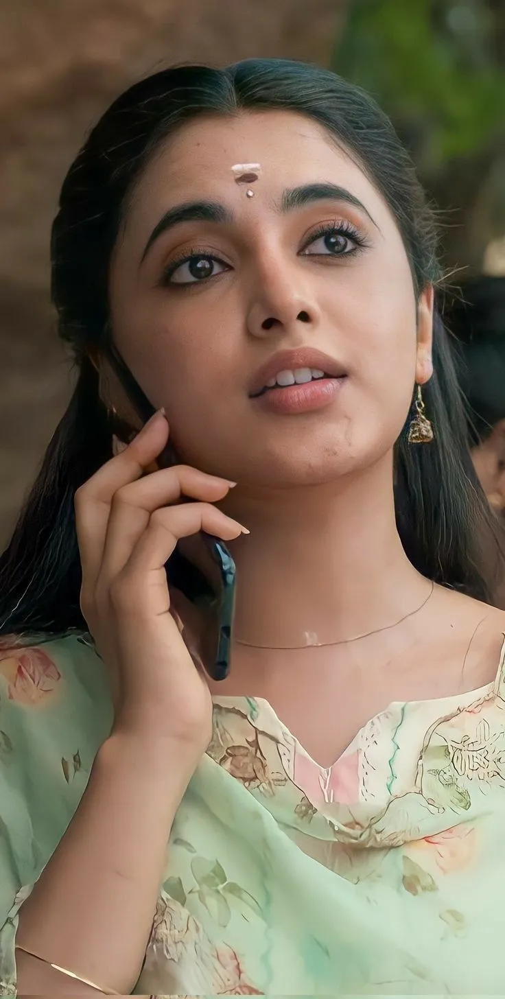 Actress Priyanka in light green outfit talking on phone