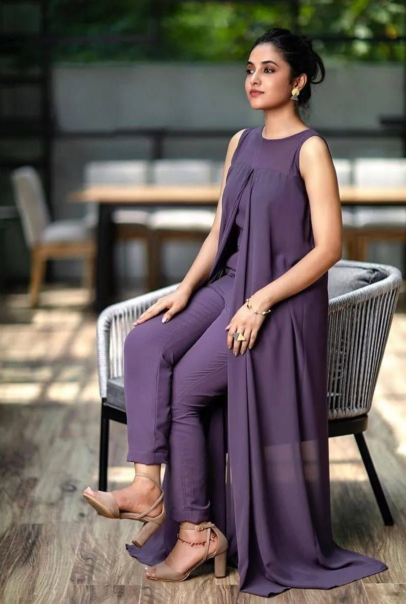 Actress Priyanka in purple outfit seated outside image