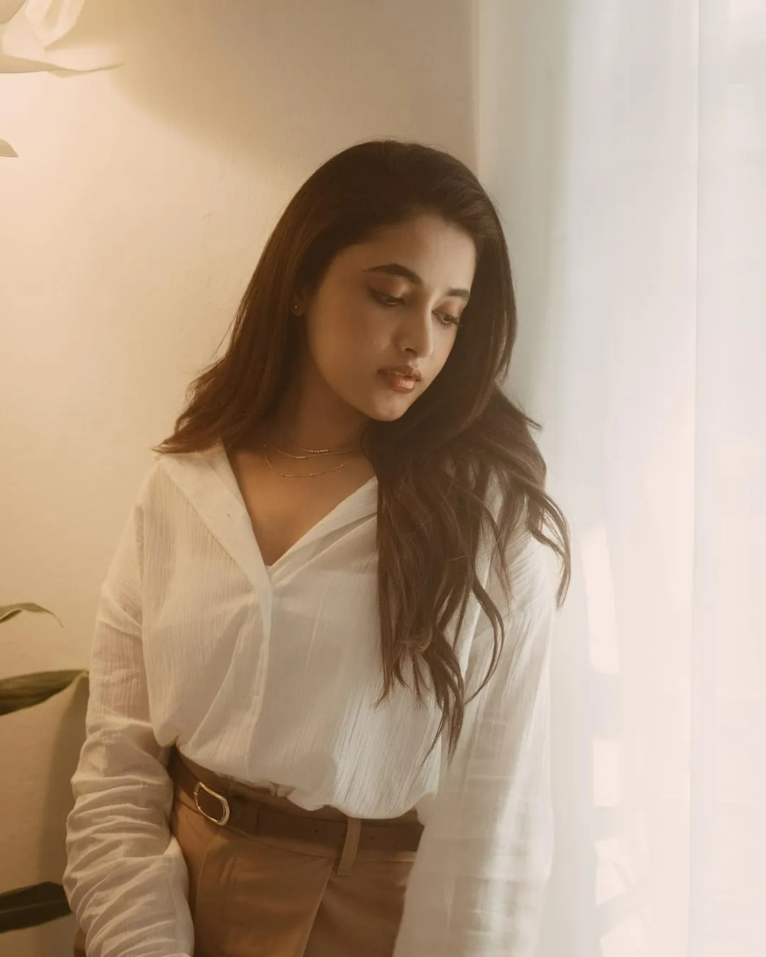 Actress Priyanka in white shirt and brown pants HD image