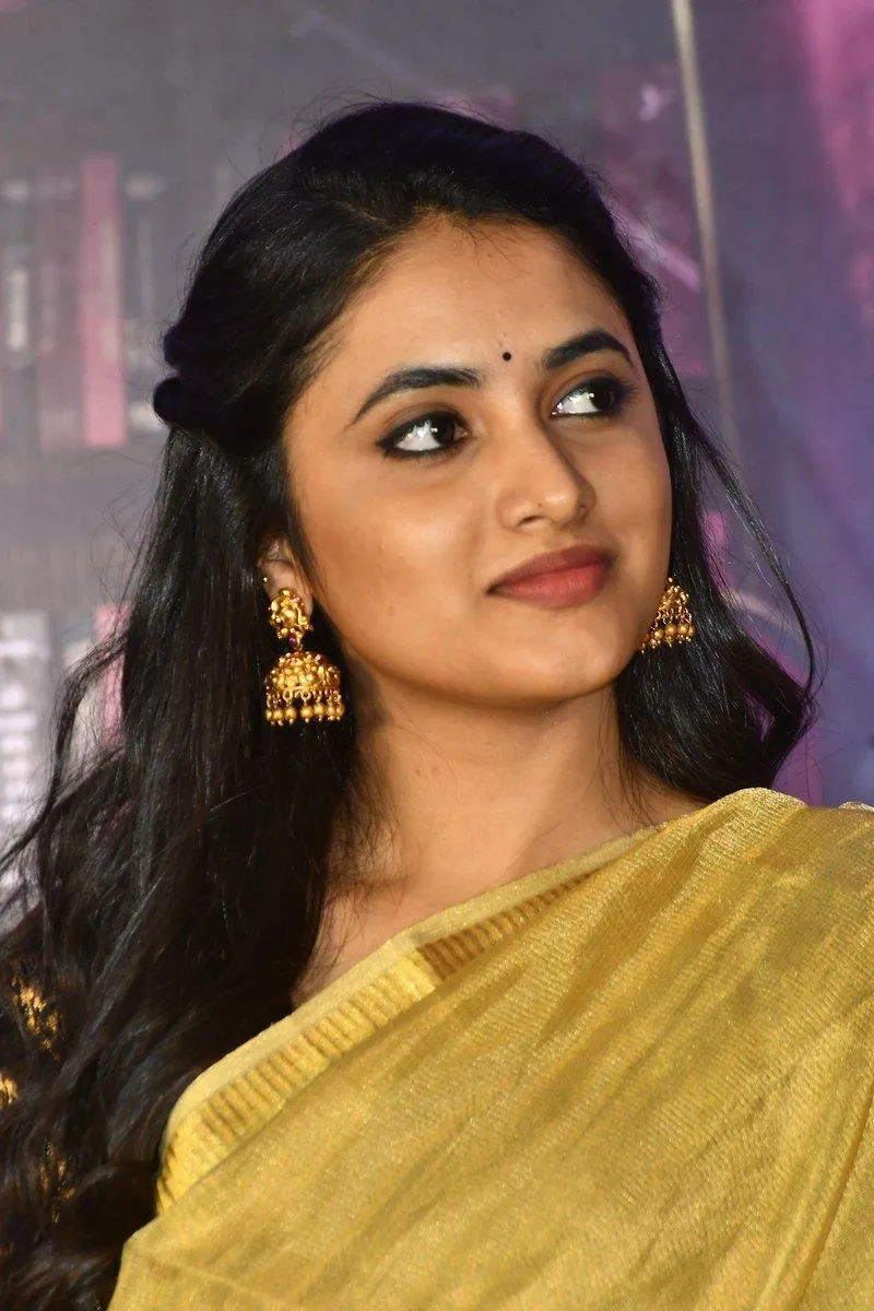 Actress Priyanka in yellow saree with graceful side profile