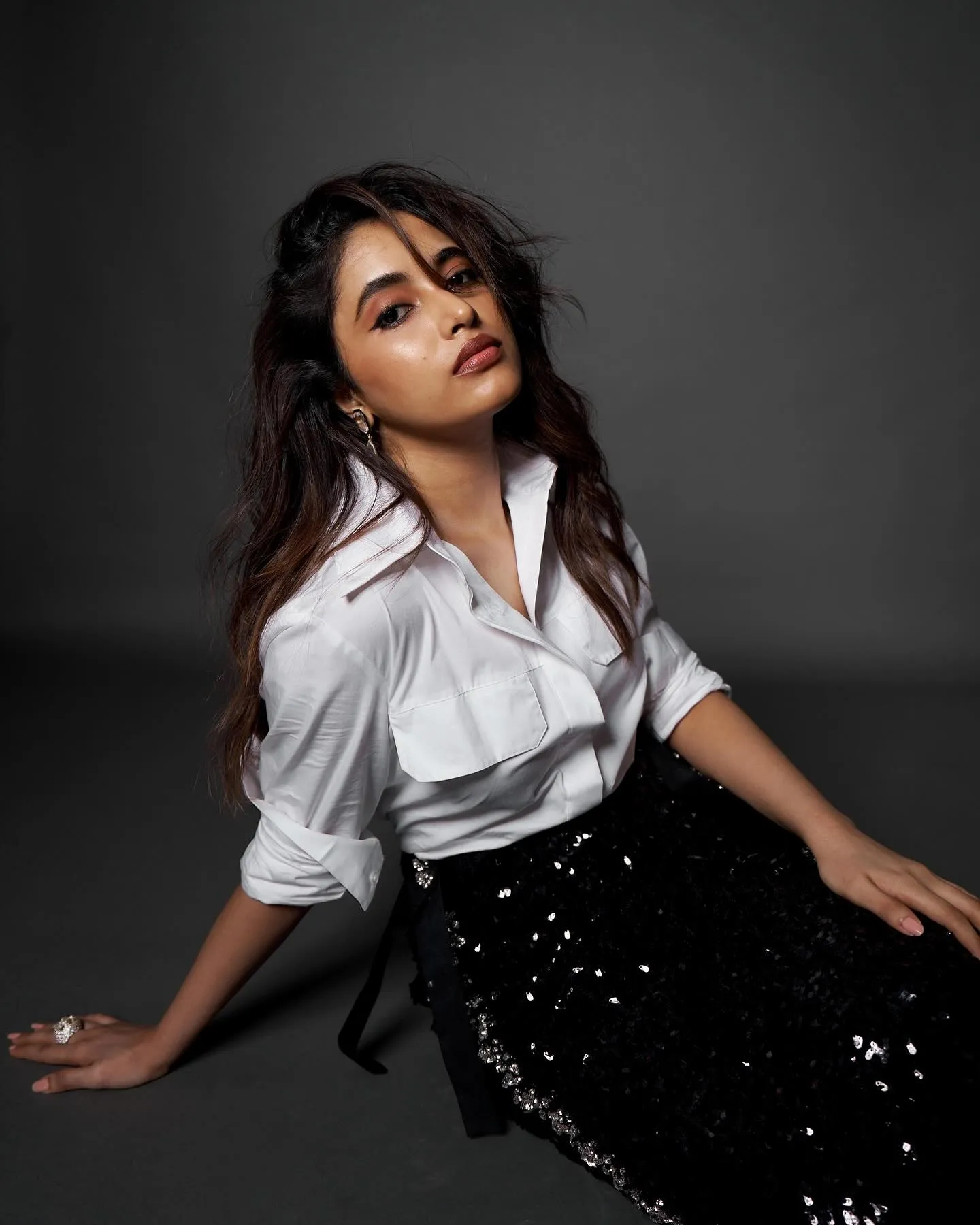 Actress Priyanka posing in black skirt and white shirt image