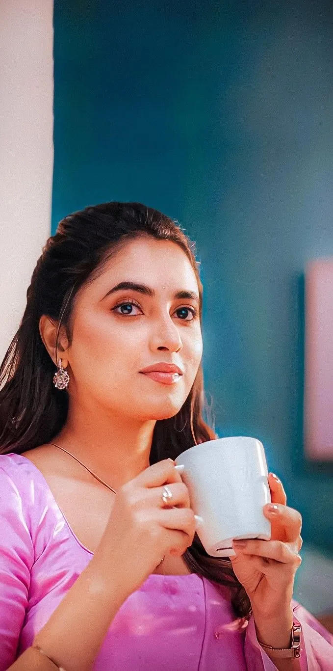 Cute Image of Priyanka Mohan in a Pink Dress Holding a Cup