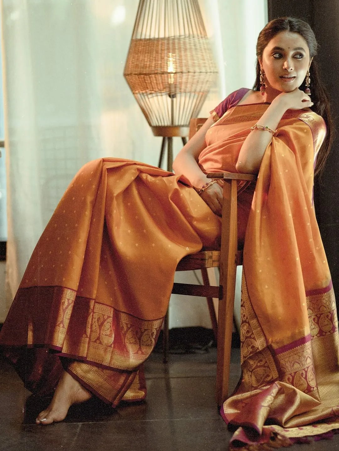 Graceful Pose of Priyanka Mohan Sitting in a Wooden Chair