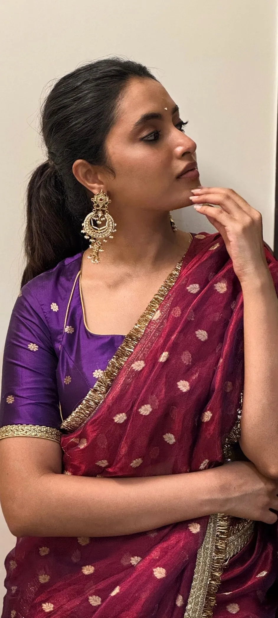 Iconic Image of Priyanka Mohan in a Maroon Saree Near Wall