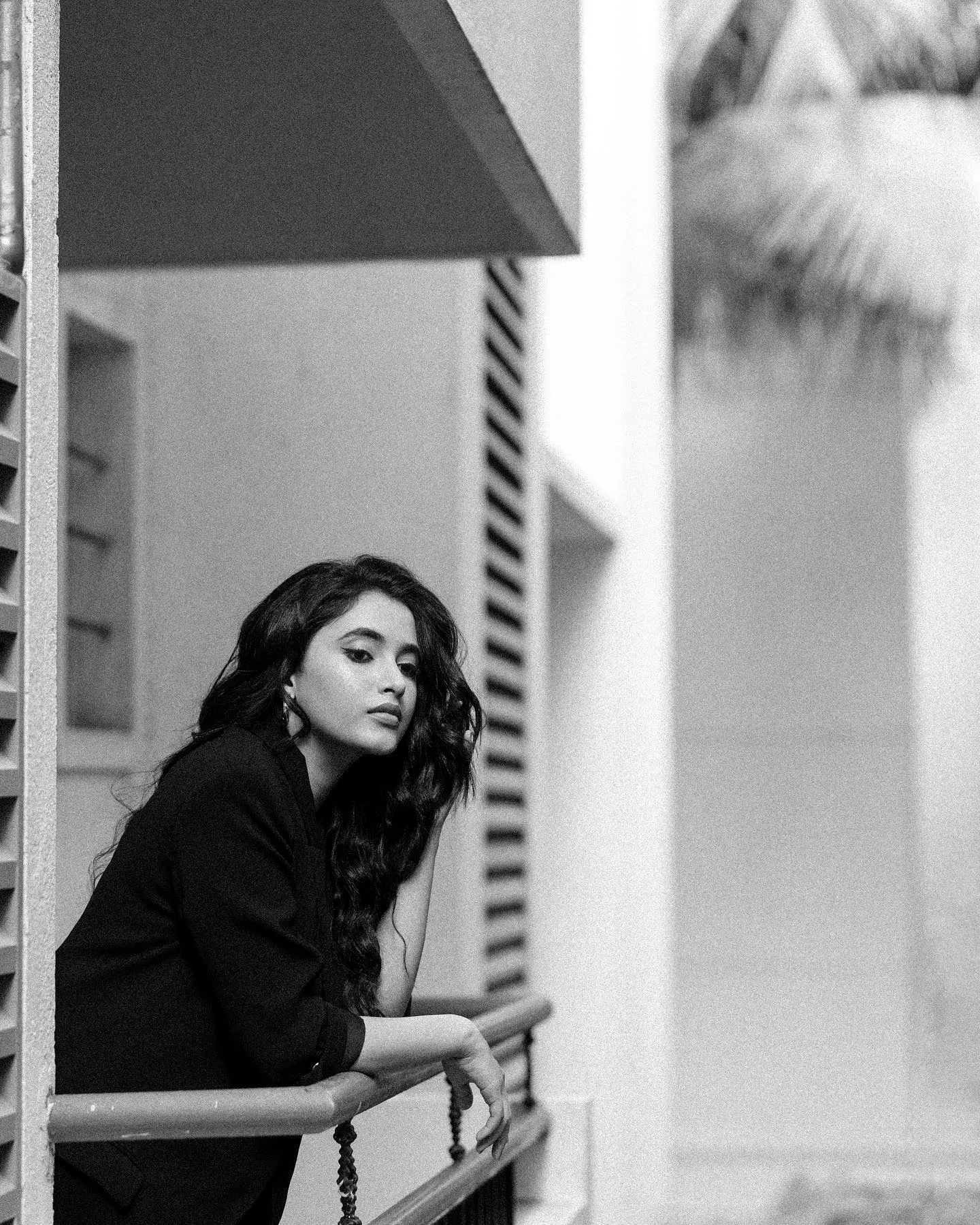Monochrome Image of Priyanka Mohan Standing on the Balcony