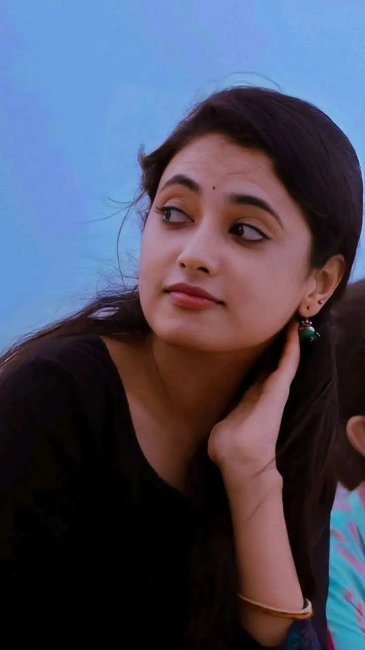 Priyanka Arul Mohan calm expression with hand touching neck