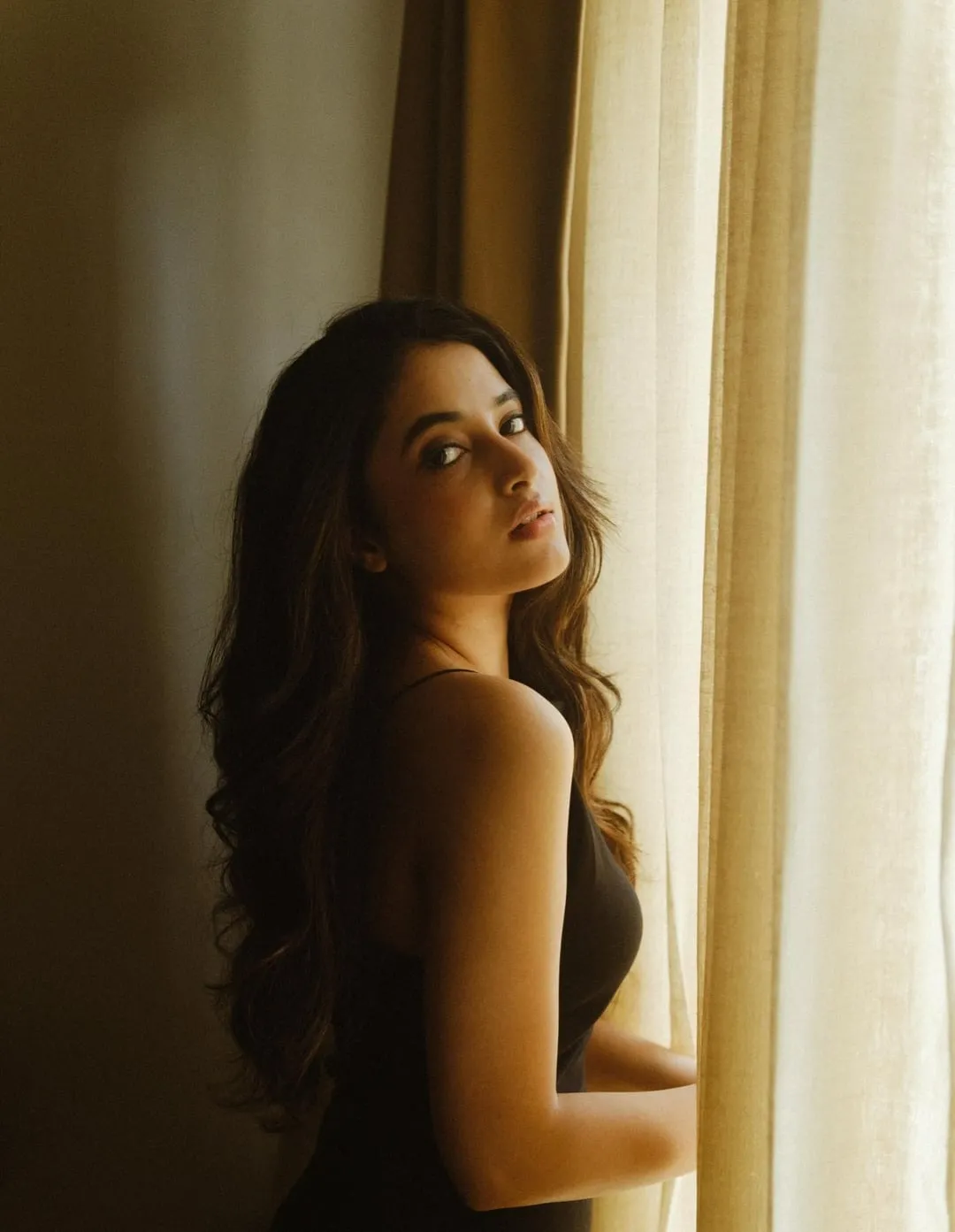 Priyanka Arul Mohan gazing out window in soft lighting HD