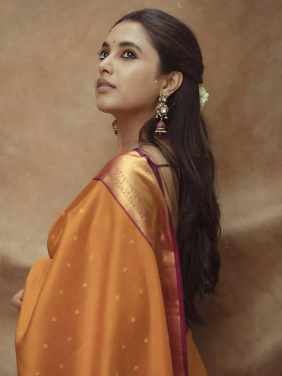 Priyanka Arul Mohan graceful in brown saree side profile