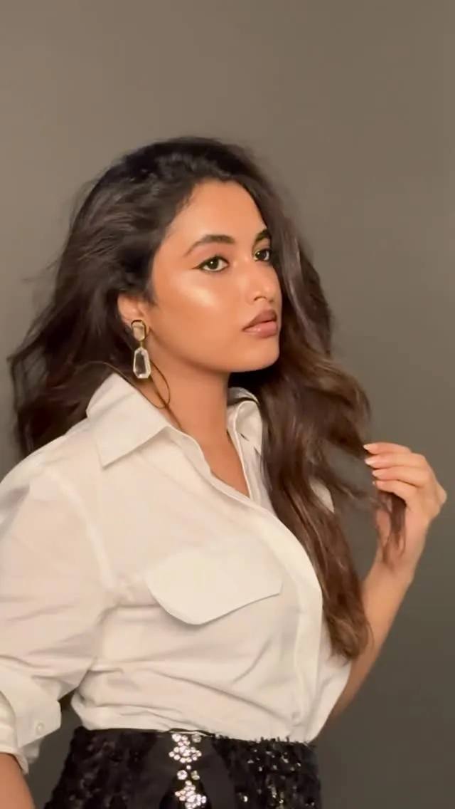 Priyanka Arul Mohan in casual white shirt and dark pants