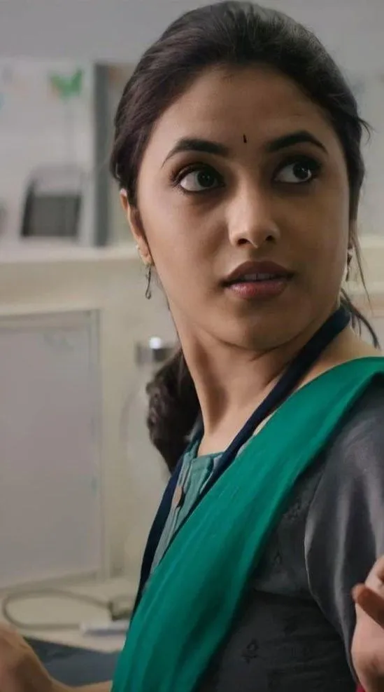 Priyanka Arul Mohan in gray dress with thoughtful look