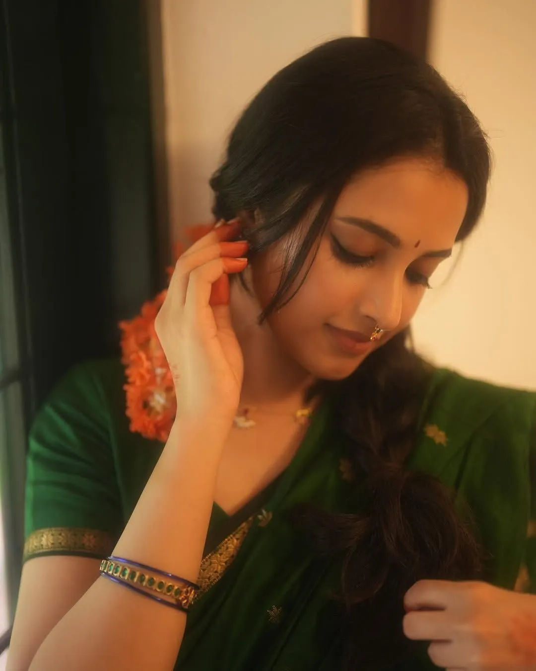 Priyanka Arul Mohan in green saree with peaceful expression
