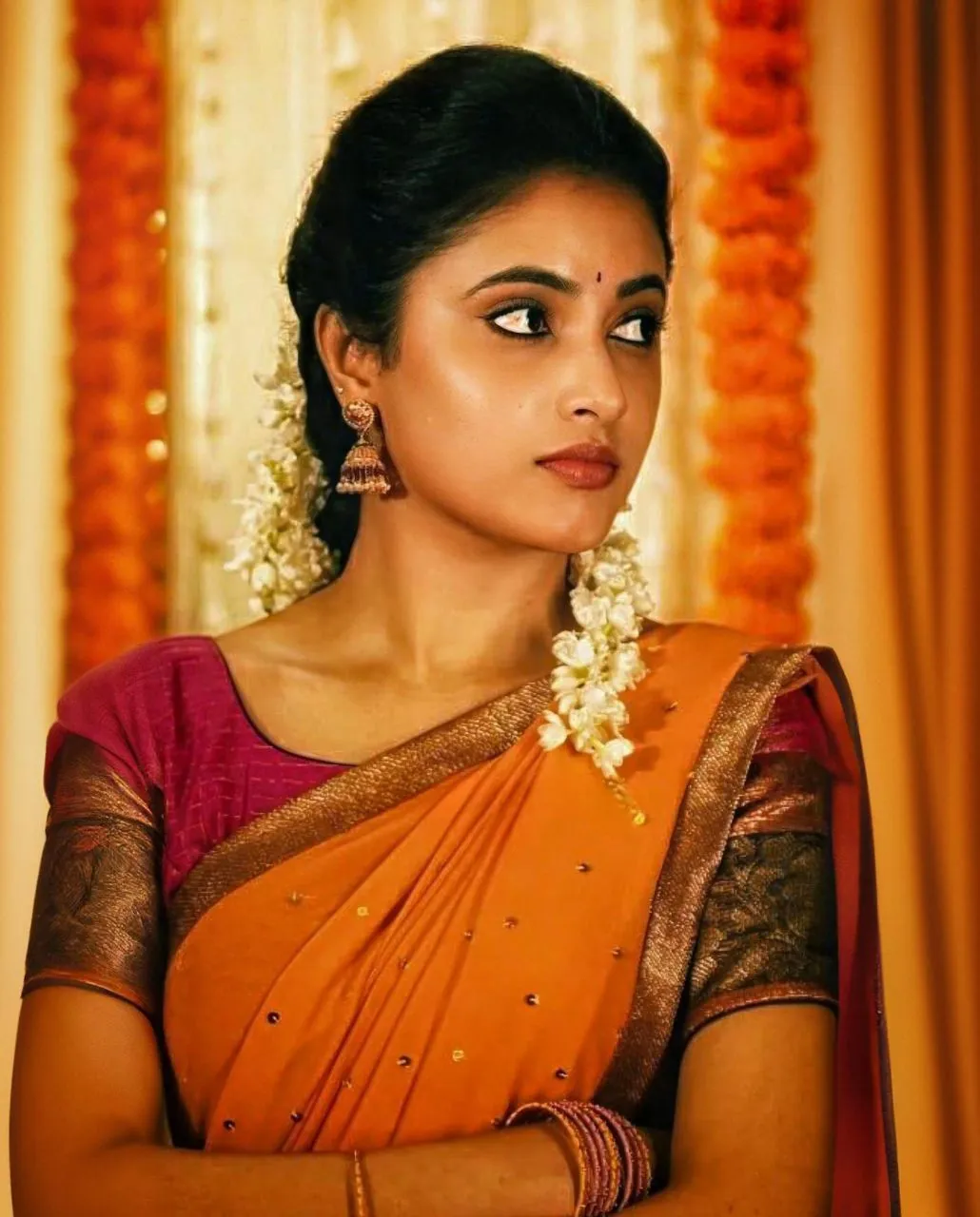 Priyanka Arul Mohan in Orange Saree Looking calmly Wallpaper
