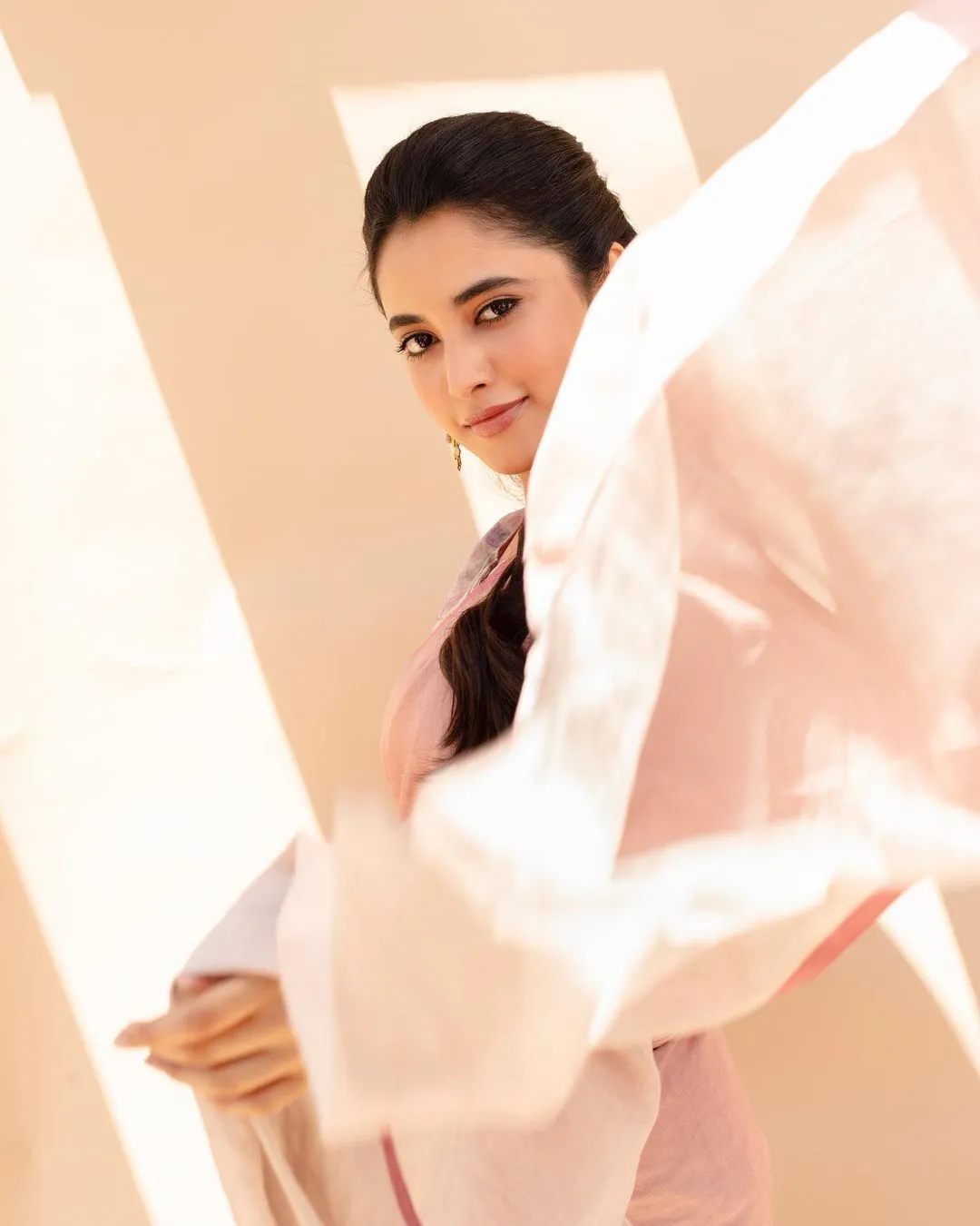 Priyanka Arul Mohan in pink flowy outfit with a soft pose