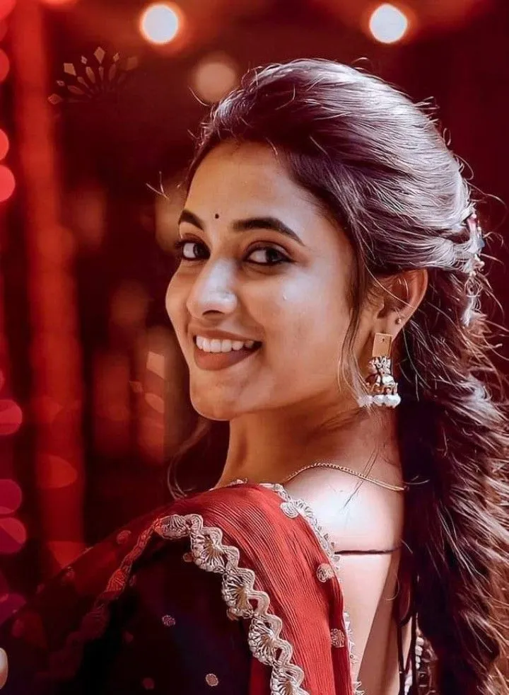 Priyanka Arul Mohan in red ethnic outfit with joyful smile